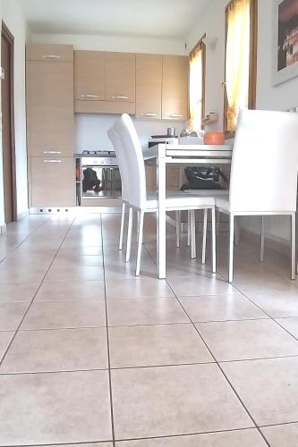 a kitchen with a white table and white chairs at CASA di SILVA tra MONTI e LAGHI PERLEDO REGOLEDO in Regoledo