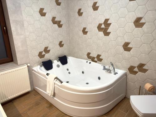 a bathroom with a tub and a toilet at Two Rivers Bran in Bran