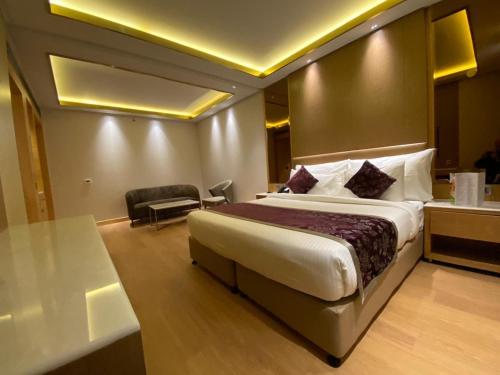 a hotel room with a large bed and a desk at Hotel Royal Infinity Near Delhi Airport in New Delhi