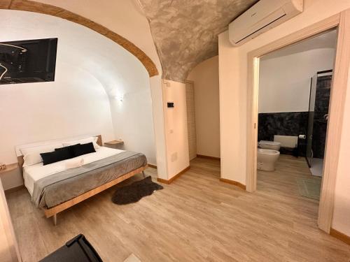 Ένα ή περισσότερα κρεβάτια σε δωμάτιο στο Centro-Archimede Rooms