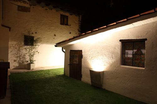 a white building with a door and a window at night at Villa Teresa in Valeggio sul Mincio