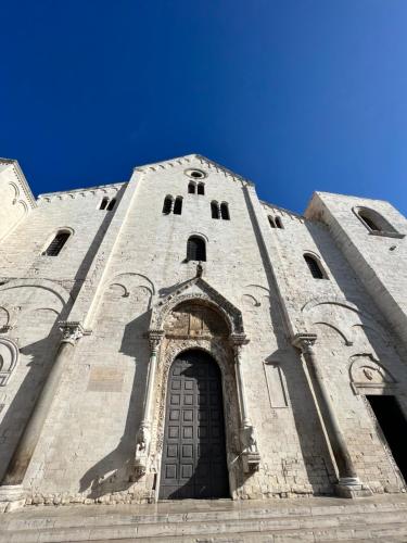 a tall tower with a door on a building at Porto Antico in Bari