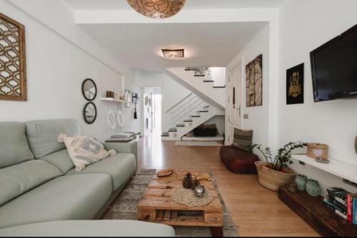 a living room with a couch and a table at La casita de vanessa in Telde