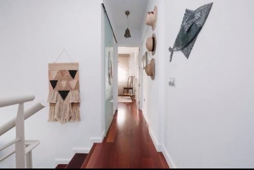 a hallway of a home with white walls and wooden floors at La casita de vanessa in Telde