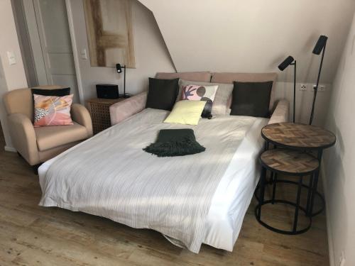 a bedroom with a large bed and a couch at Fachwerkliebe Ornes 3 in Olsberg