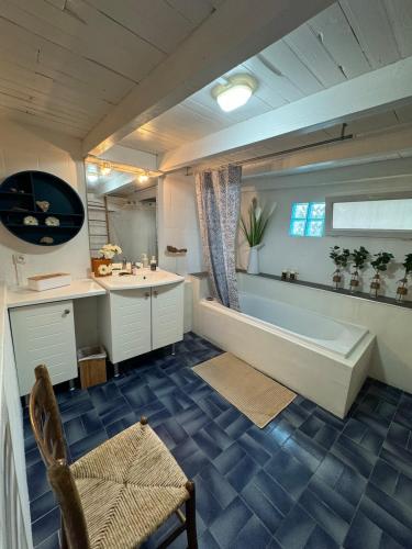 une grande salle de bain avec une baignoire et un lavabo dans l'établissement La maison Auguste - vue imprenable sur la Cité, à Carcassonne