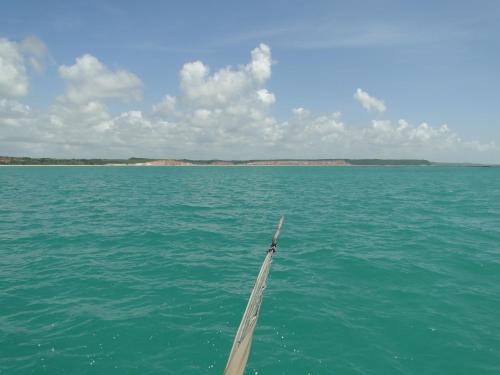 a boat in the middle of a large body of water at Hotel Pousada Arco Iris in Barra de Santo Antônio
