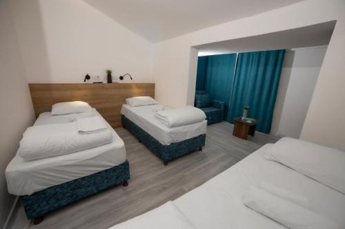 a hotel room with two beds and a mirror at Blue Topas Otel in Burhaniye