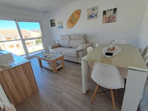 ein Wohnzimmer mit Tisch und Couch in der Unterkunft Beach House in Puerto de Mazarrón