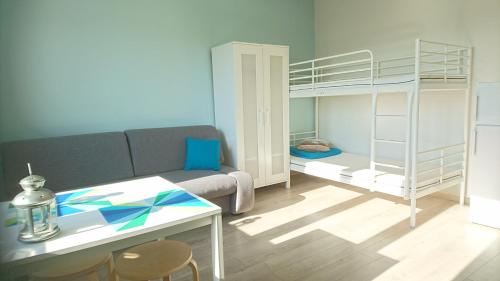 a living room with a couch and a bunk bed at Pokoje Gościnne Apartamenty in Międzyzdroje