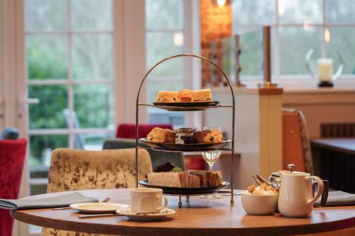 a table with a tray of pastries on a table at Gomersal Park Hotel & Bazaar Spa in Cleckheaton