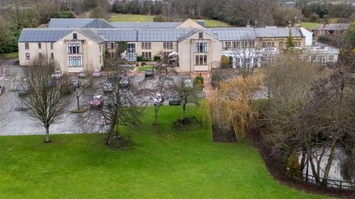 an aerial view of a large house with a green yard at Gomersal Park Hotel & Bazaar Spa in Cleckheaton