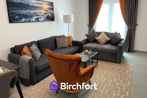 a living room with a couch and a table at Birchfort - Newly renovated unique 1 bedroom apartment in Dubai