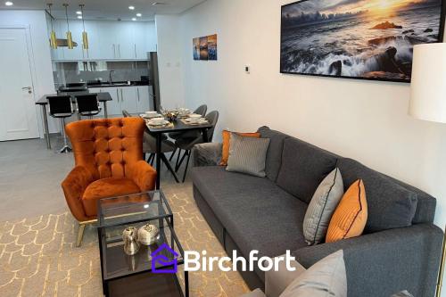 a living room with a couch and a table at Birchfort - Newly renovated unique 1 bedroom apartment in Dubai