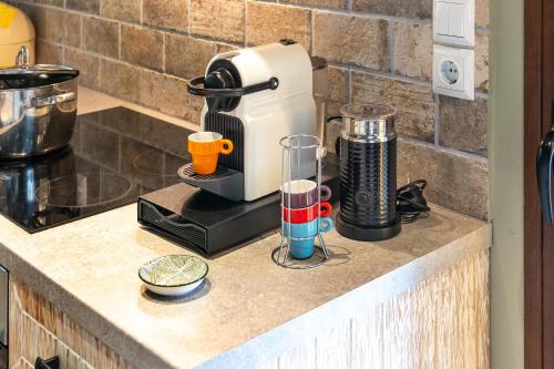 a coffee maker and two cups on a counter at Chalet Perivoli in Perivólion