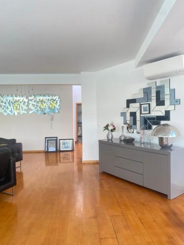 a living room with a table and a couch at Great V4 Villa with Private Salt Pool in Quinta do Anjo