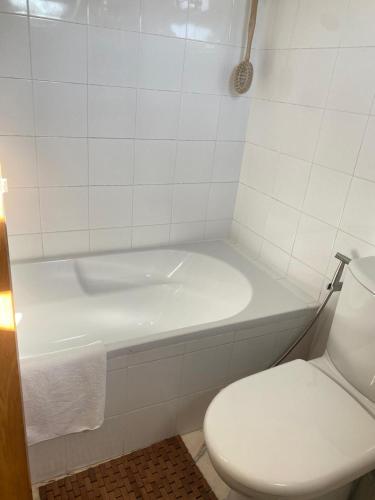 a bathroom with a white tub and a toilet at Great V4 Villa with Private Salt Pool in Quinta do Anjo