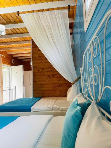 a bedroom with a large bed with a curtain at Vila Viorica in Mamaia Sat/Năvodari