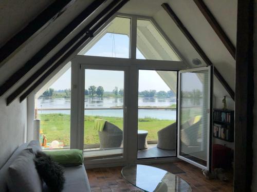 a room with a large window with a view of the water at Elbblick Schnackenburg in Schnackenburg