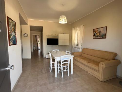 a living room and kitchen with a couch and a table at casa vacanze GLICINE Zambrone in Zambrone