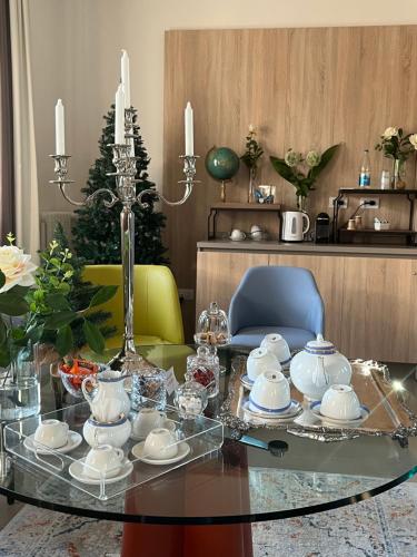 a glass table with a tea set on top of it at Al Santuario di Fiorano Charming Hostel in Fiorano Modenese