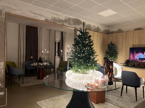 a living room with a christmas tree on a table at Al Santuario di Fiorano Charming Hostel in Fiorano Modenese