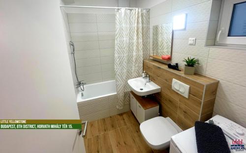 a bathroom with a sink and a toilet and a shower at Little Americas National Parks Apartments in Budapest