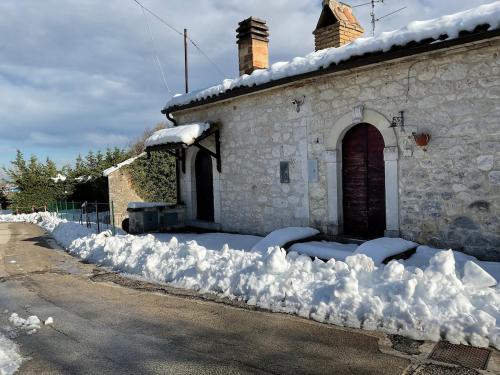 a pile of snow on the side of a house at Sleeps up to 7 in the Majella in Rapino