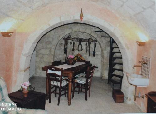 a dining room with a table and a stone archway at Sleeps up to 7 in the Majella in Rapino