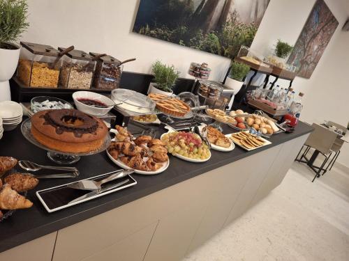 a buffet with many different types of food on a counter at Al Santuario di Fiorano Charming Hostel in Fiorano Modenese