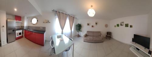 a kitchen and a living room with a couch at Hôtel Montaigne & Spa - Cannes Centre in Cannes