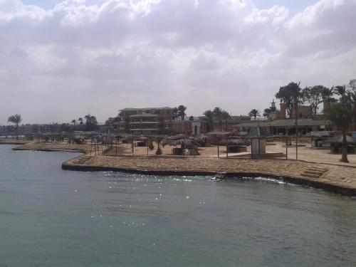 a pool of water in front of a resort at Fanara Apartments Armed Forces in Fayed