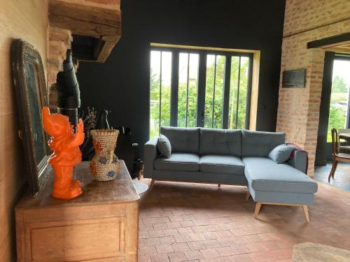 a living room with a couch and a table at Les 9 Hirondelles in Charrin