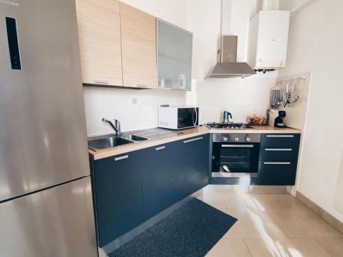 a kitchen with blue cabinets and a sink at Apartment in Siena with private parking in Siena