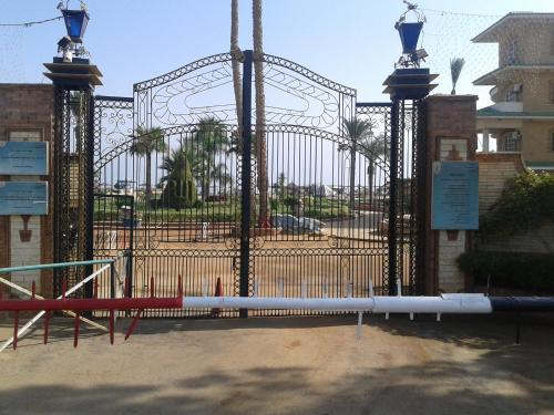 a gate to a park with a playground at Fanara Apartments Armed Forces in Fayed