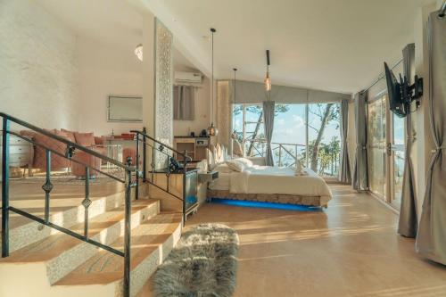 a bedroom with a bed and a large window at Java Boutique Hotel in Lushoto