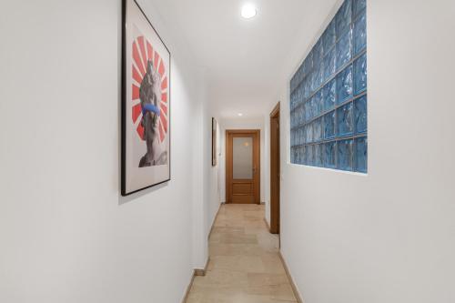 a hallway with two pictures on the wall and a hallway with at Las Canteras Coastal Rooms - Only adults in Las Palmas de Gran Canaria
