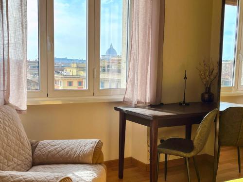 a room with a desk and a chair and windows at Vatican Charm Retreat in Rome