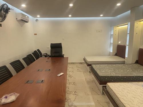 a conference room with a wooden table and chairs at GH Grand Park in Angamali