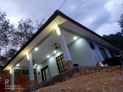 a white house with lights in front of it at D'Intan Villa Gerik in Gerik