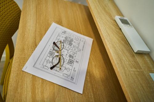 a piece of paper on a wooden table with a drawing at Hotel Gran Vía by gaiarooms in Salamanca