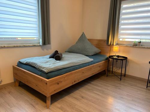 a bed with a teddy bear on it in a room at Gästehaus Trockau in Pegnitz