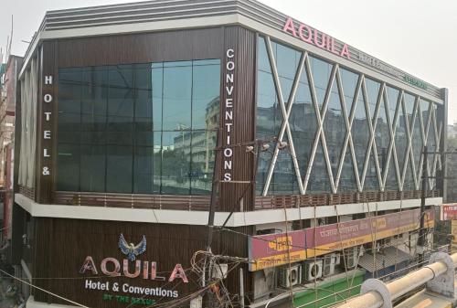 a building with a sign on the side of it at Aquila Hotel and Convention by The Nexus in Patna