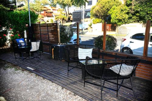 a group of chairs sitting on a wooden deck at Hotel Los Ángeles in Mar del Plata