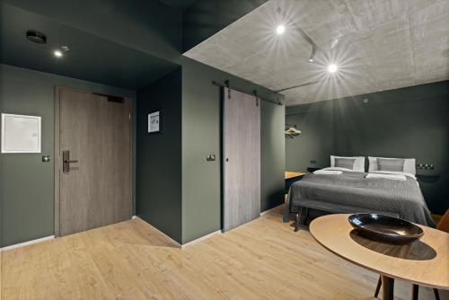 a bedroom with a bed and a table at Aurora Nooks by Heimaleiga in Reykjavík