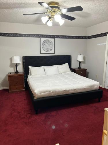 a bedroom with a bed with a ceiling fan at Southern Large Lake Front Custom Estate, Sleeps 16 in Olive Branch