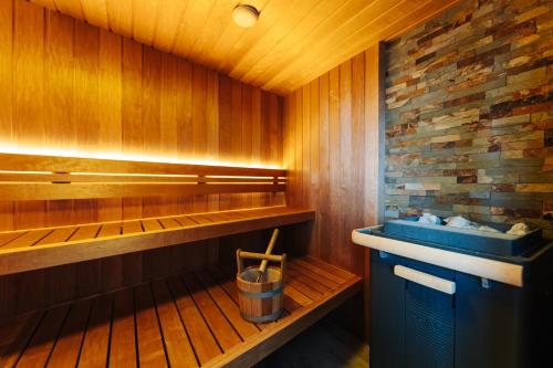 a sauna with a blue sink and wooden walls at Hotel City in Villach