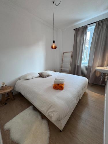a bedroom with a bed with an orange object on it at vakantiewoning Kloosterpad in Damme