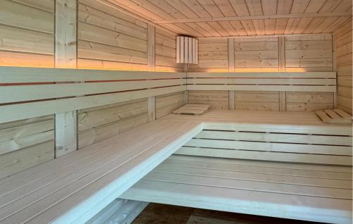 an empty sauna with wooden walls and wooden floors at Awesome Home In Netzeband With Sauna in Netzeband