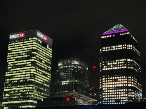 two tall buildings in a city at night at Opulent Retreat in London